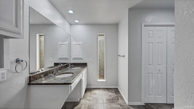 bathroom with a textured ceiling and vanity