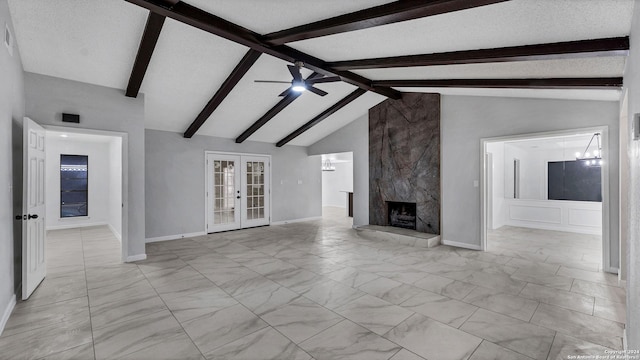 unfurnished living room featuring a fireplace, vaulted ceiling with beams, french doors, and a textured ceiling