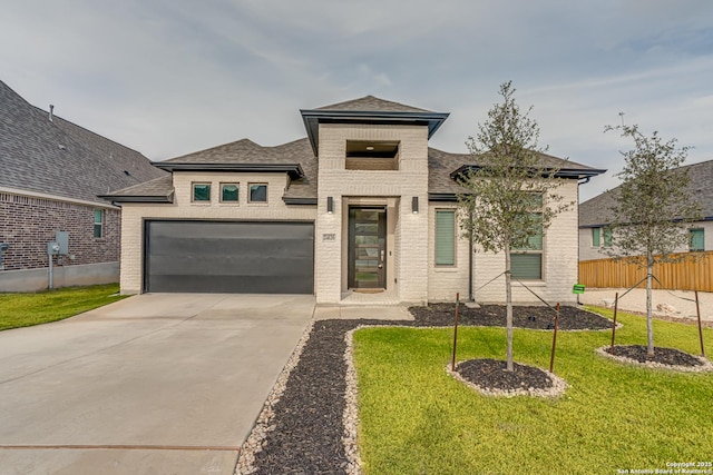 prairie-style house with a front lawn and a garage