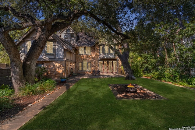 view of yard with a fire pit and a patio