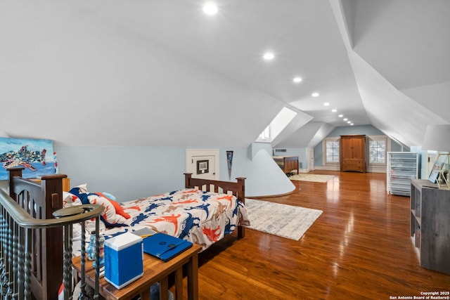 bedroom featuring lofted ceiling with skylight, recessed lighting, and wood finished floors