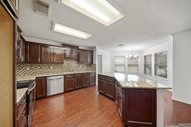 kitchen with hanging light fixtures, stainless steel appliances, a center island, light stone countertops, and dark hardwood / wood-style floors