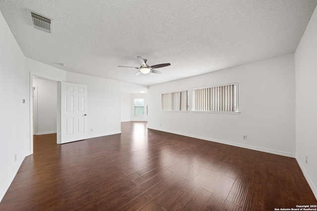 unfurnished room with dark hardwood / wood-style flooring, ceiling fan, and a textured ceiling