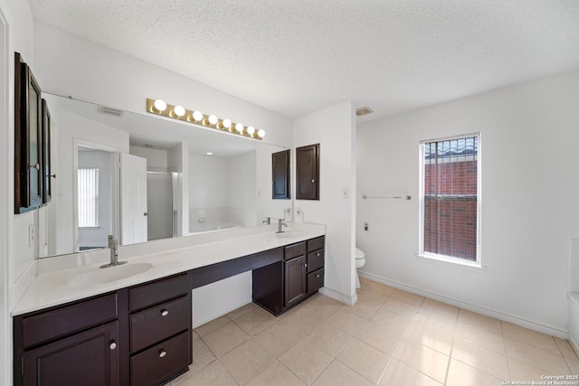 full bathroom with tile patterned flooring, toilet, a textured ceiling, independent shower and bath, and vanity