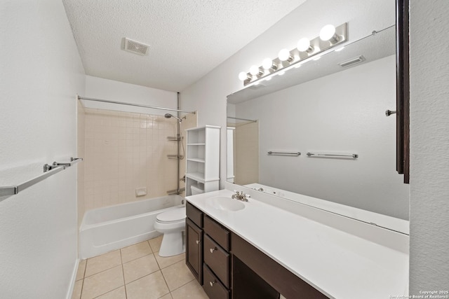 full bathroom featuring tile patterned floors, toilet, a textured ceiling, vanity, and tiled shower / bath combo