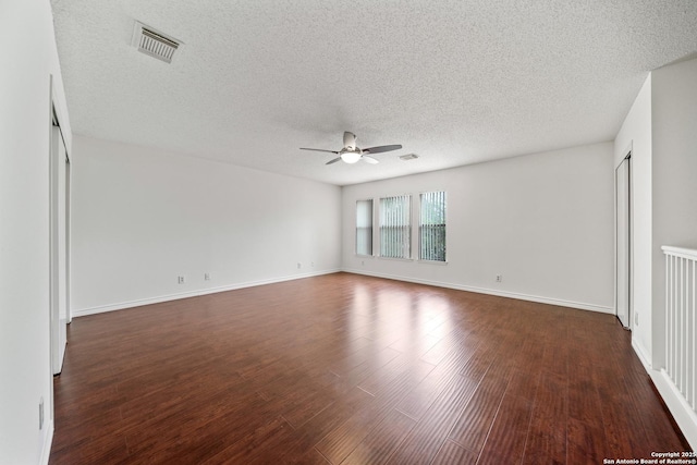 unfurnished room with dark hardwood / wood-style flooring, ceiling fan, and a textured ceiling