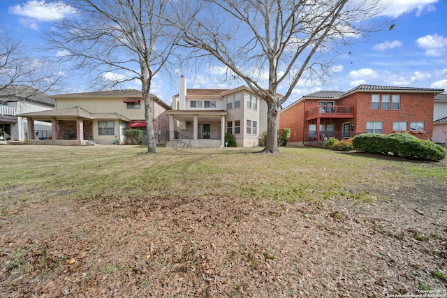 back of house with a lawn