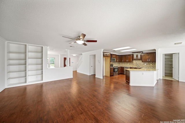 unfurnished living room featuring a textured ceiling, ceiling fan, dark hardwood / wood-style floors, and ornamental molding