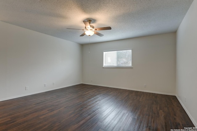 unfurnished room with a textured ceiling, dark wood finished floors, a ceiling fan, and baseboards