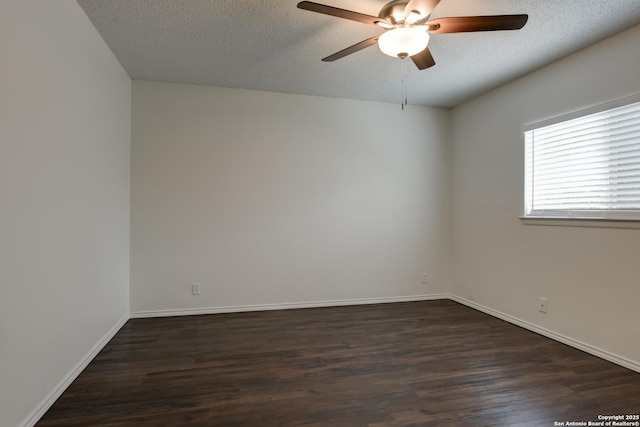 empty room featuring dark wood-style floors, ceiling fan, baseboards, and a textured ceiling