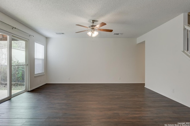 unfurnished room featuring dark wood-style floors, ceiling fan, a textured ceiling, and visible vents