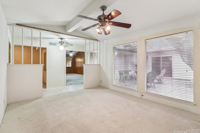 spare room with lofted ceiling with beams, ceiling fan, visible vents, and light colored carpet