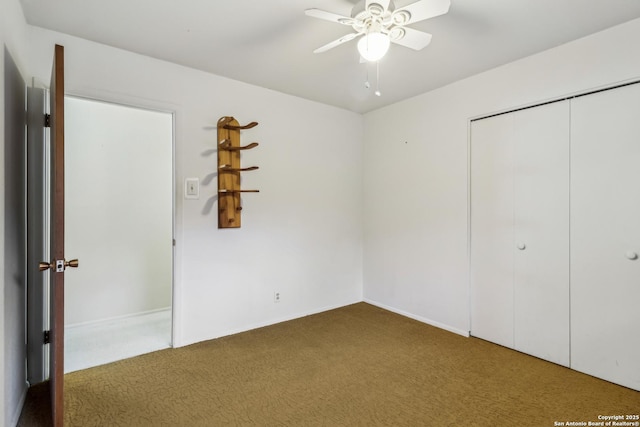 unfurnished bedroom with a closet, a ceiling fan, and carpet flooring