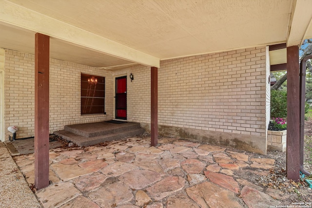 view of exterior entry featuring a patio