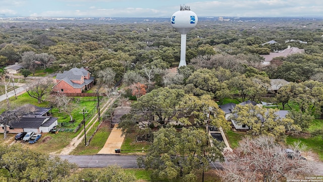 drone / aerial view featuring a residential view and a view of trees