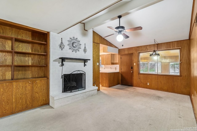 unfurnished living room featuring wood walls, a brick fireplace, and light colored carpet