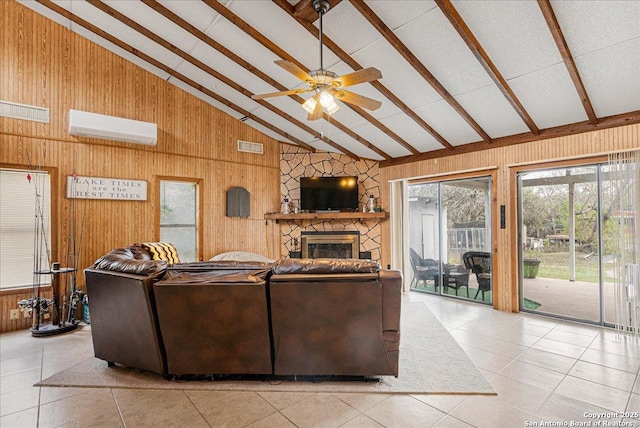 tiled living room featuring high vaulted ceiling, a stone fireplace, a wall mounted AC, and wooden walls