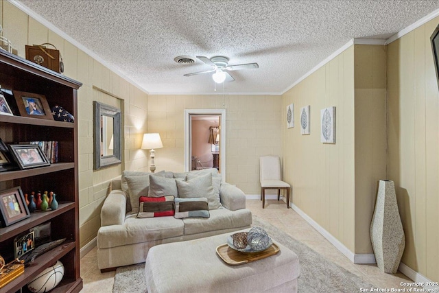 living room featuring a textured ceiling, ornamental molding, and ceiling fan