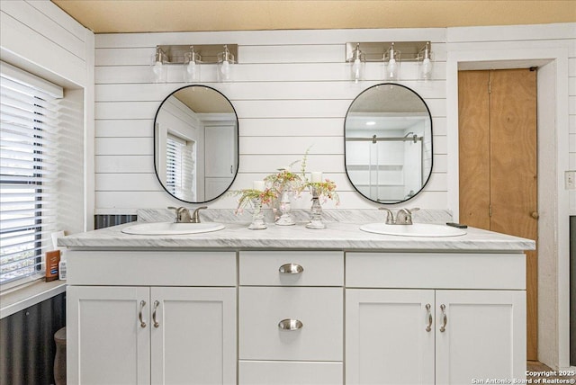 bathroom with vanity and wood walls