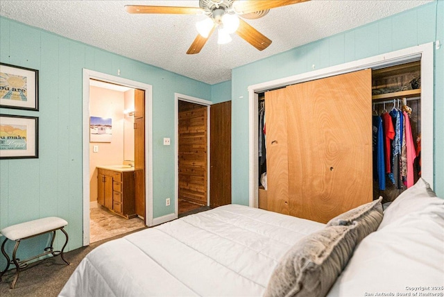 bedroom with ceiling fan, a textured ceiling, a closet, and ensuite bathroom