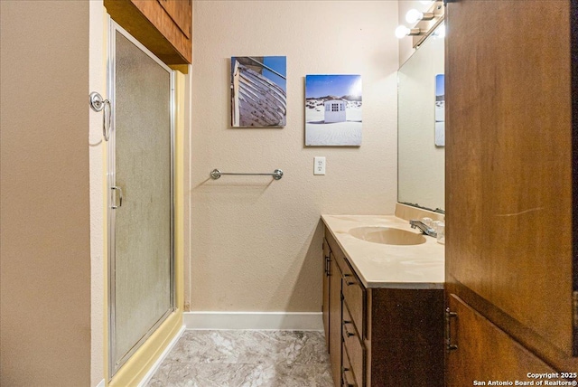 bathroom featuring an enclosed shower and vanity