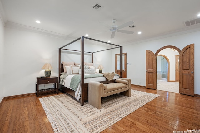 bedroom with light hardwood / wood-style floors, ceiling fan, and ornamental molding