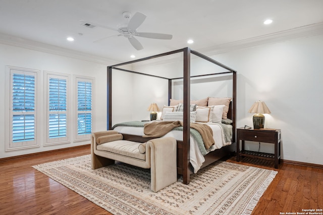 bedroom with hardwood / wood-style floors, ceiling fan, and crown molding