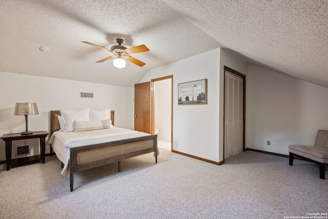 bedroom featuring vaulted ceiling, ceiling fan, a closet, and a textured ceiling