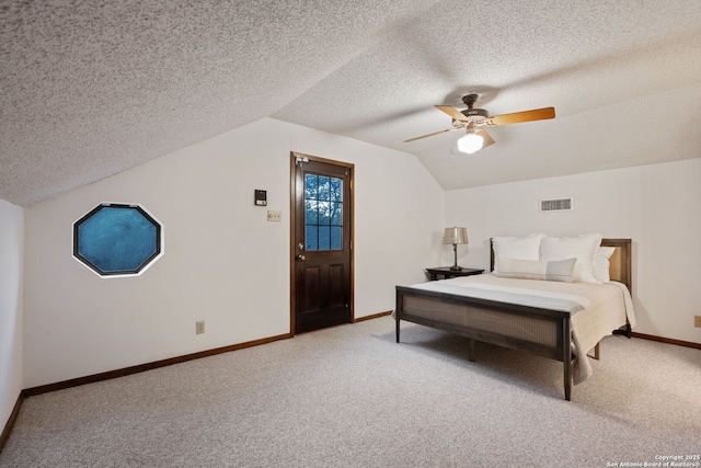 bedroom featuring vaulted ceiling, ceiling fan, carpet floors, and a textured ceiling