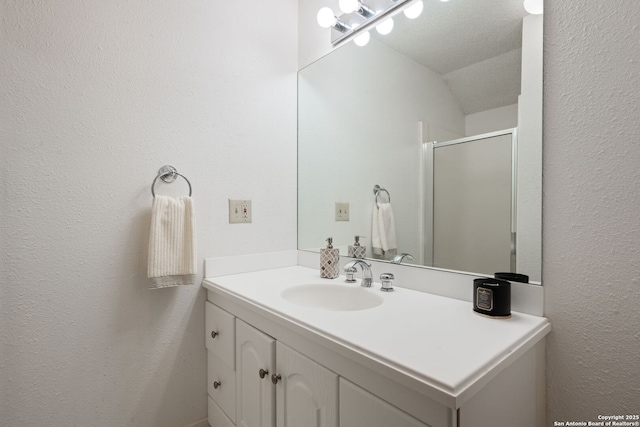 bathroom with vanity and a shower with door