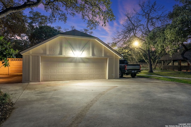 view of garage at dusk