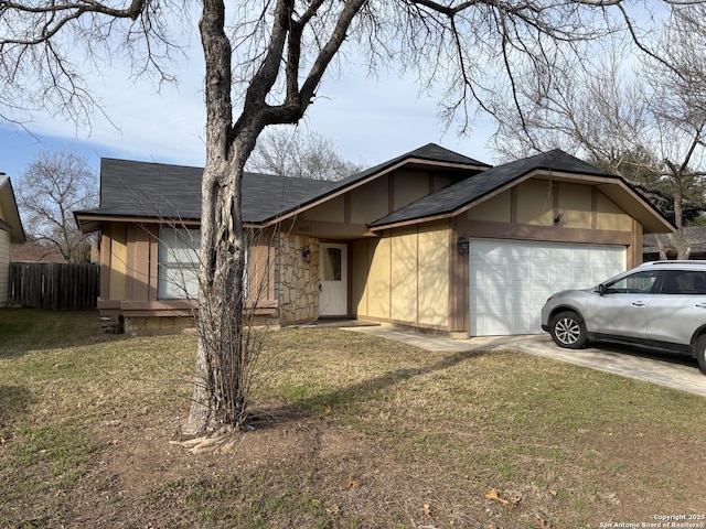 ranch-style home featuring a front yard and a garage