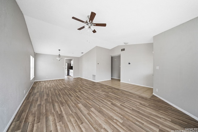 unfurnished living room featuring lofted ceiling, ceiling fan, and wood-type flooring