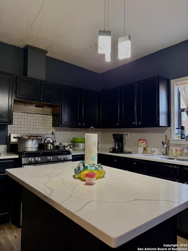 kitchen with tasteful backsplash, pendant lighting, and a center island