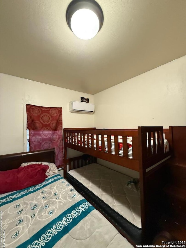 bedroom featuring a wall mounted AC