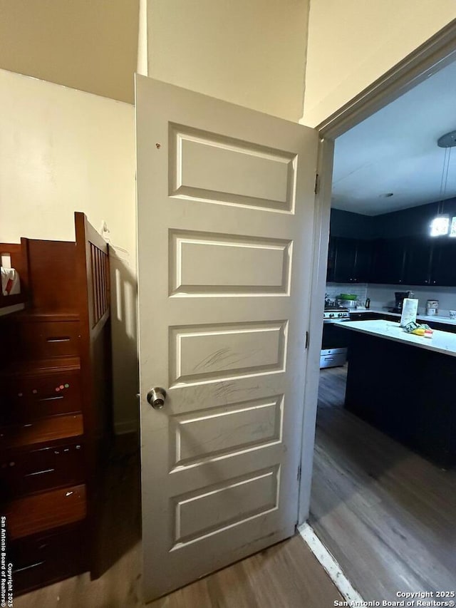 interior space with hardwood / wood-style flooring and gas range