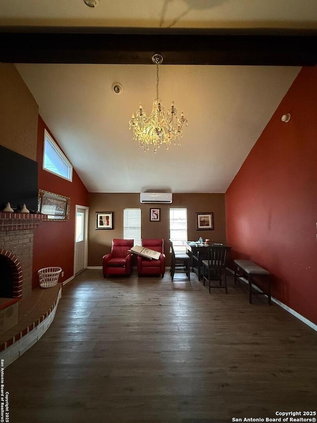 unfurnished living room with a fireplace, dark wood-type flooring, a wall mounted air conditioner, and a notable chandelier