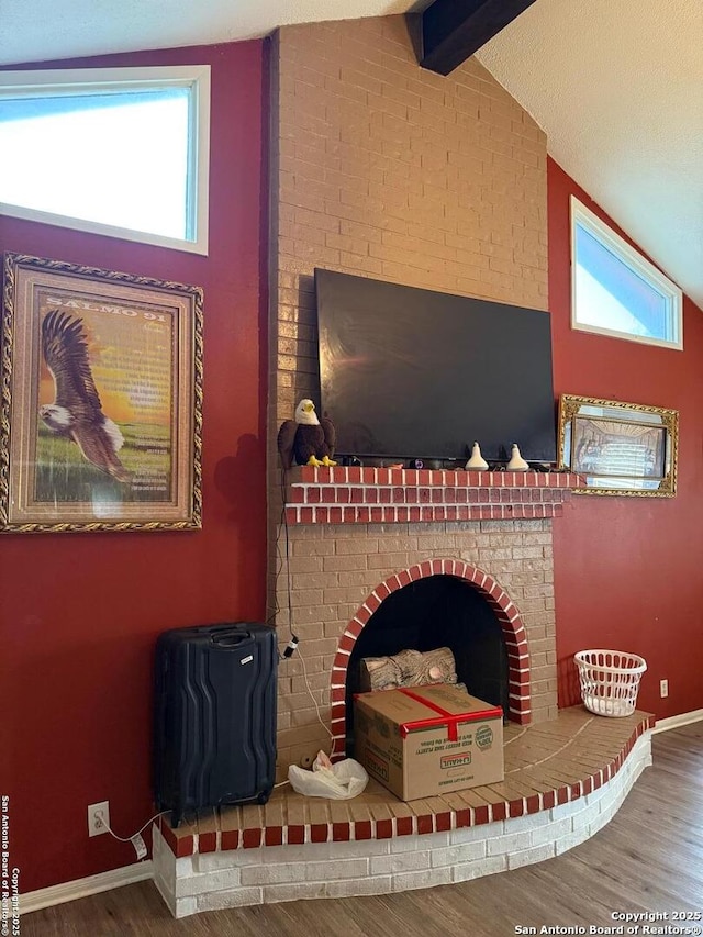 room details featuring hardwood / wood-style floors, a fireplace, and beam ceiling