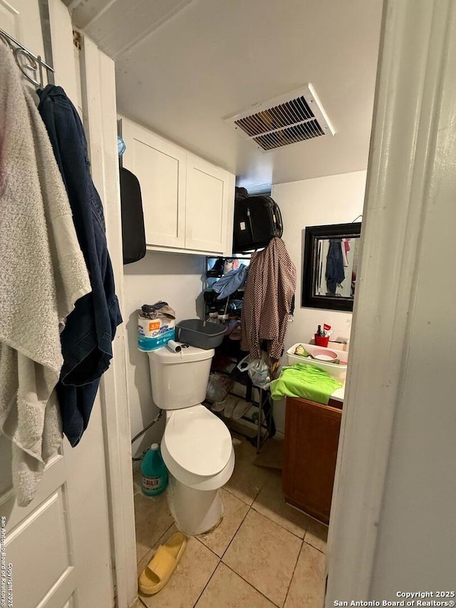 bathroom with toilet and tile patterned flooring