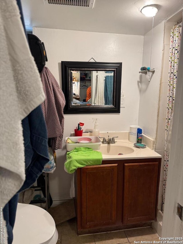 bathroom with tile patterned floors, toilet, and vanity