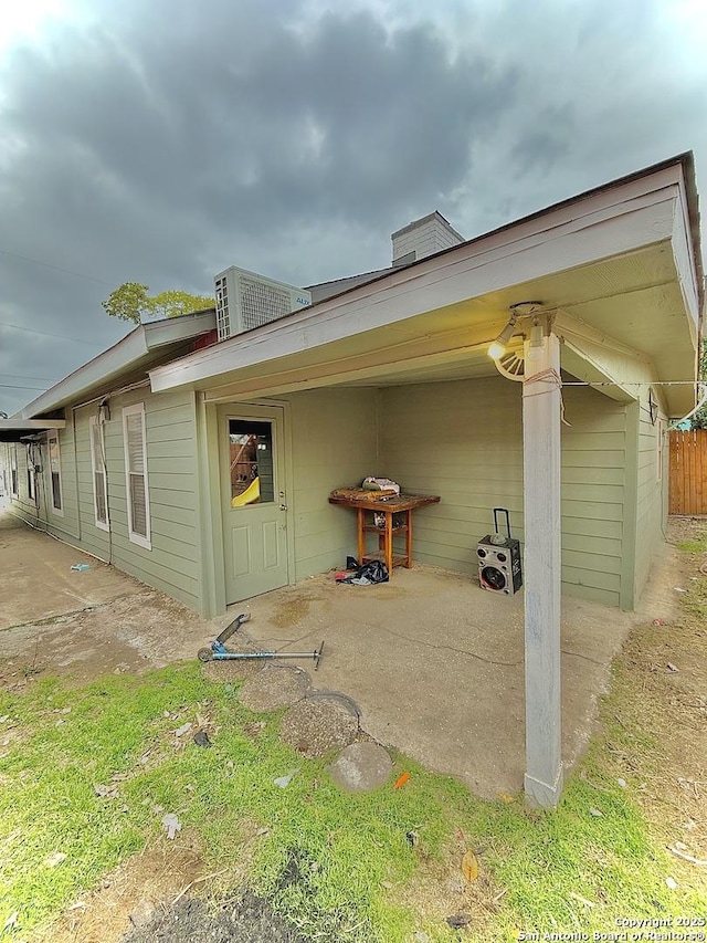 view of property exterior with a patio area