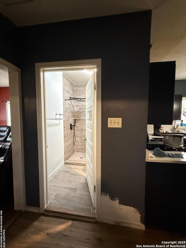 hallway with hardwood / wood-style flooring