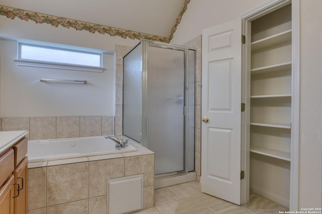 bathroom featuring independent shower and bath, tile patterned flooring, and vanity