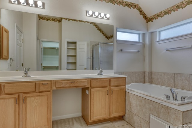 bathroom with shower with separate bathtub and vanity