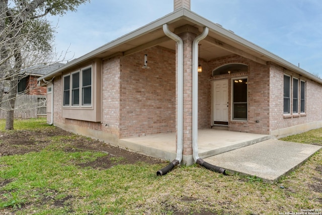 exterior space featuring a lawn and a patio area