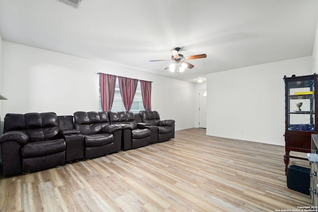 living room featuring ceiling fan and light hardwood / wood-style flooring