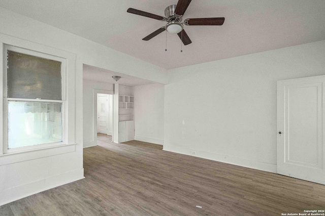 spare room featuring dark hardwood / wood-style flooring and ceiling fan