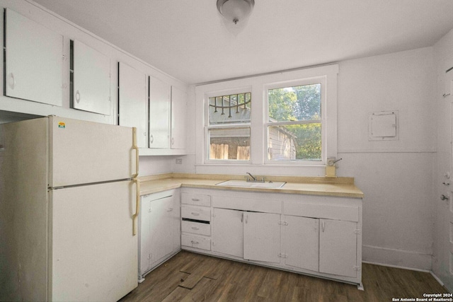 kitchen with white cabinets, white refrigerator, sink, and dark hardwood / wood-style flooring