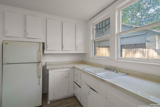 kitchen featuring white cabinetry, white refrigerator, sink, and dark hardwood / wood-style floors