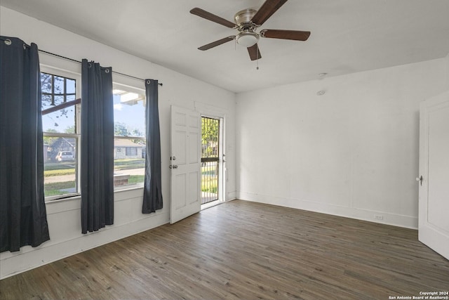 unfurnished room with ceiling fan and dark hardwood / wood-style floors